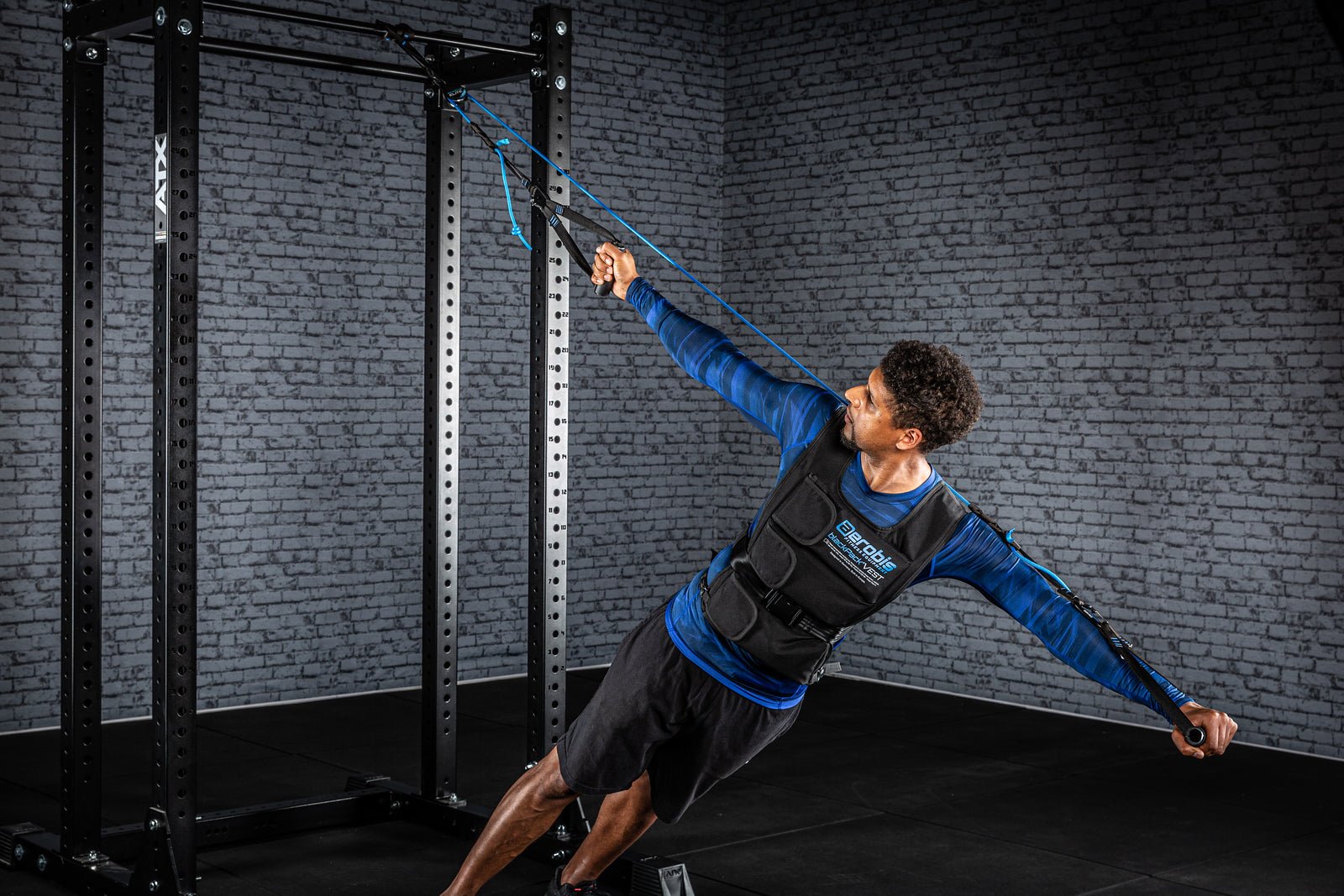 Athlete performing a dynamic rotational core exercise with a sling trainer