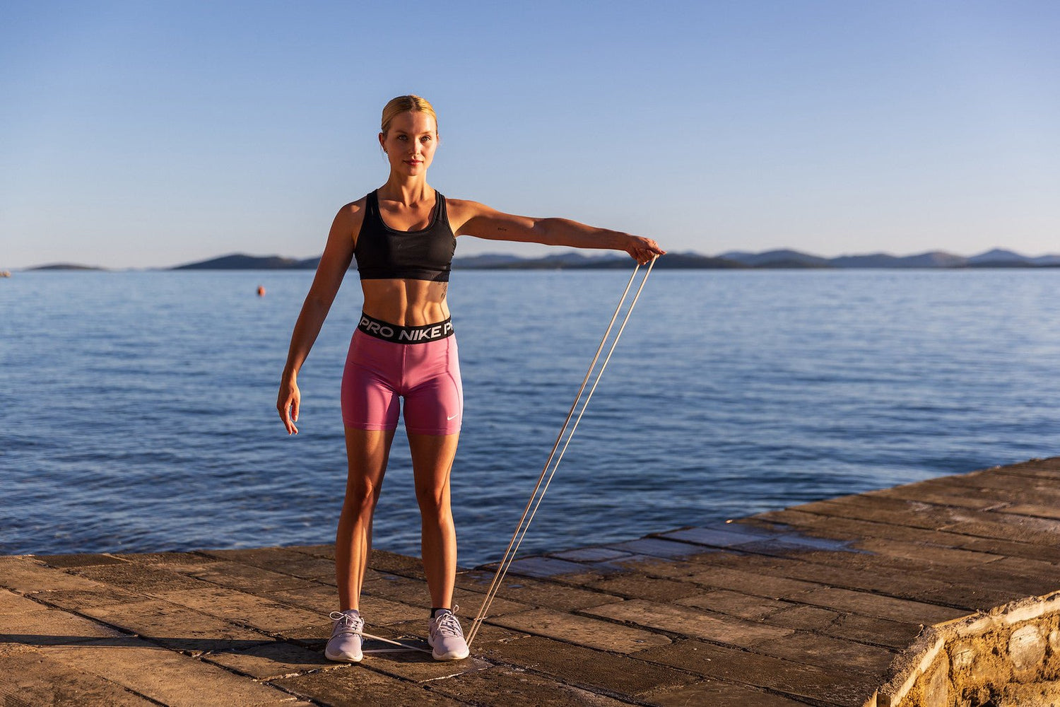Athlete training outdoors with an aerobis Powerband resistance band