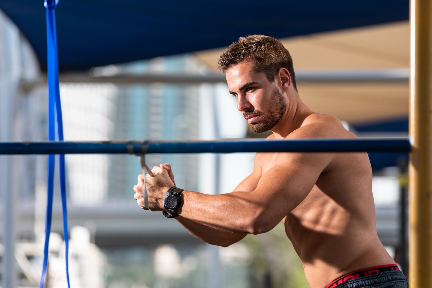Athlete performing a pallof press with an aerobis Powerband anchored at chest height