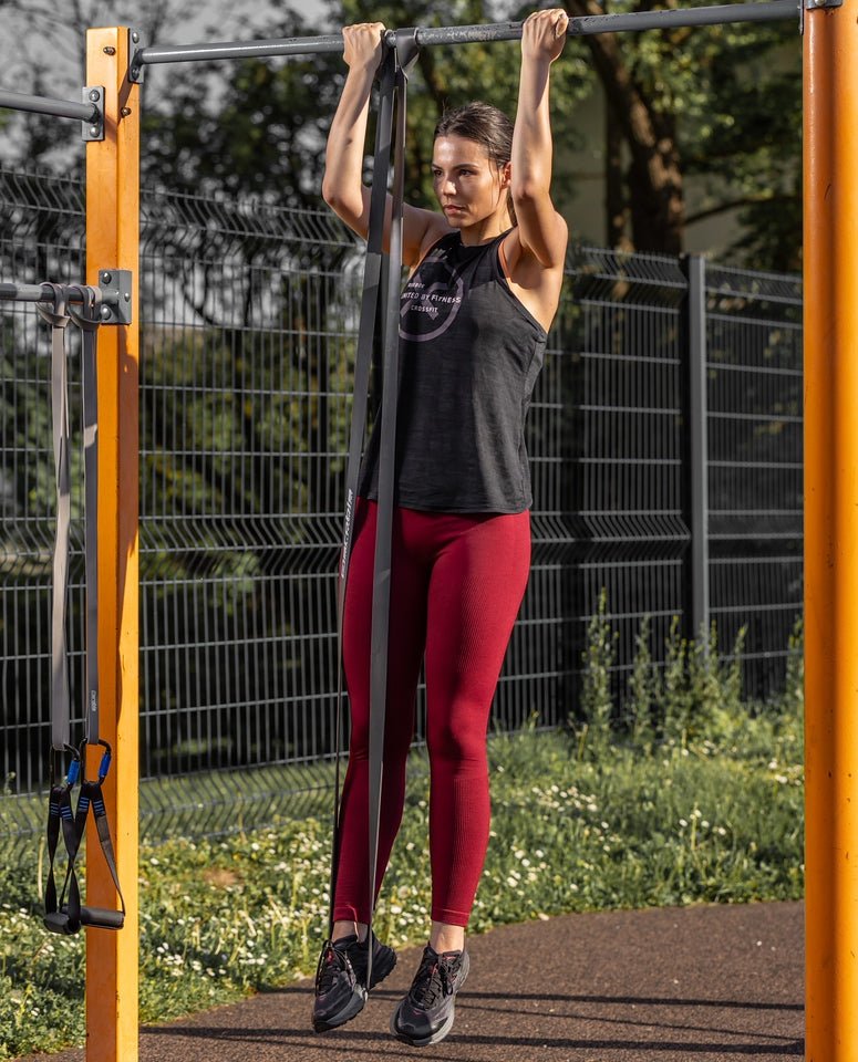 Athlete doing a band-assisted pull-up with an aerobis Powerband
